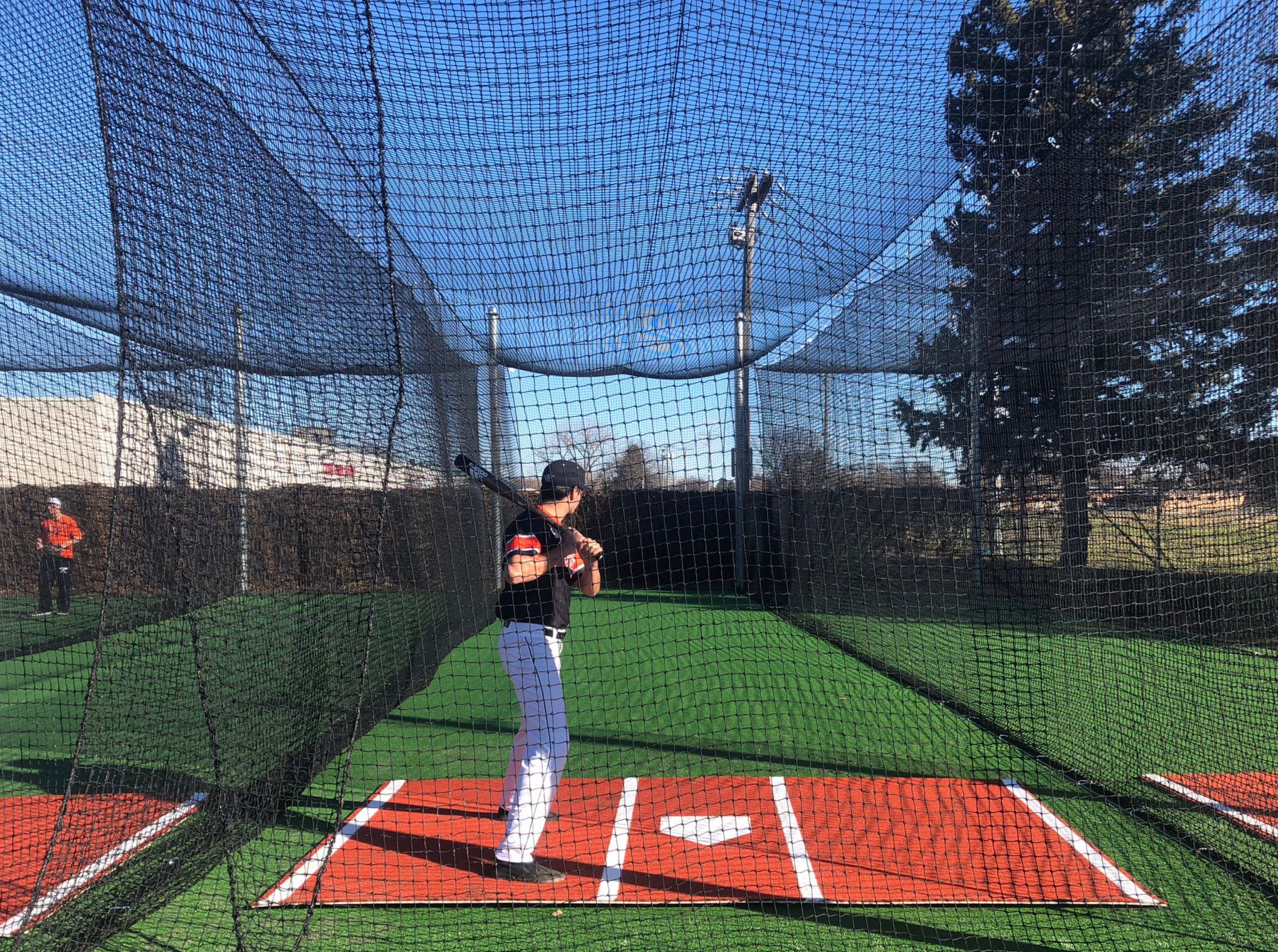 Picture of baseball player in a batting cage